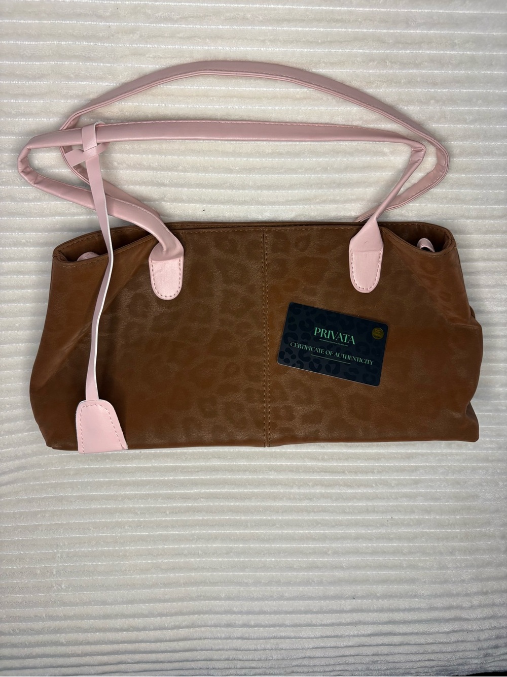 Privata’s Brown Leopard Print Shoulder Bag with Pink Trim